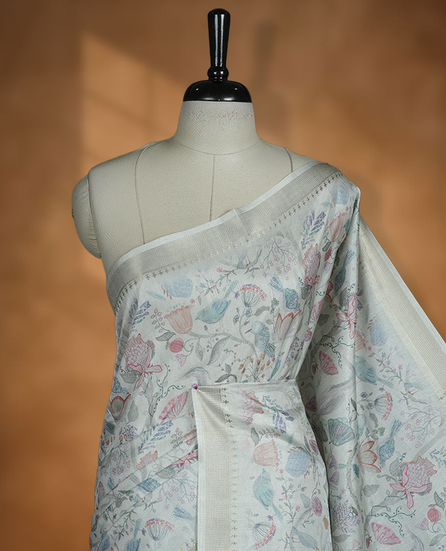 Mint green colour semi tussar silk saree featuring all over floral and leaf motifs on the body with a subtle self border and tasselled pallu, paired with a matching blouse.