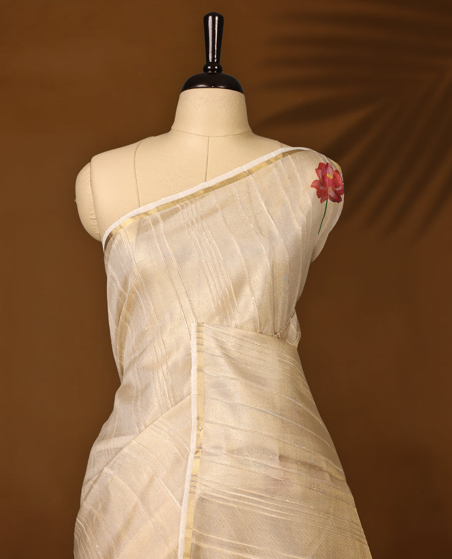 Ethereal off white colour organza Kerala saree adorned with hand painted pink lotus motifs and a subtle zari style border, Lightweight and graceful, paired with a matching blouse & perfect for festive celebrations and elegant gatherings.
