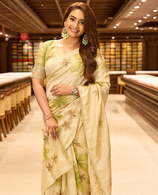Light pastel green colour pure tussar silk saree featuring elegant hand painted floral designs, beautifully highlighted with subtle gotta work, paired with a matching blouse.
