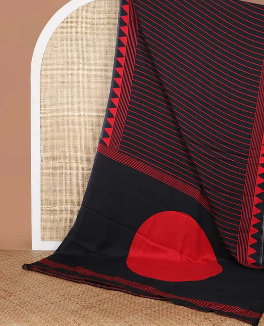 Black sem imodal crepe saree adorned with red vertical line prints, complemented by a temple border and circle butta design on the pallu, paired with a matching printed blouse.