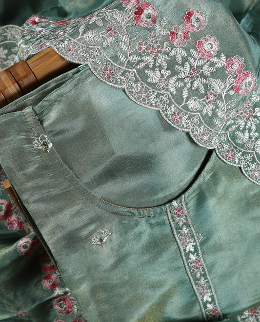Sea green colour churidar material adorned with delicate floral thread embroidery in white and pink, paired with a plain matching bottom and embroidered dupatta, perfect for festive occasions and celebrations.