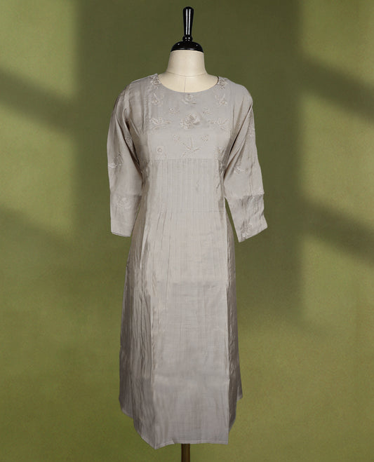 Beige colour straight fit kurti featuring a round neck, 3/4th sleeves, and delicate floral embroidery on the bodice and sleeves