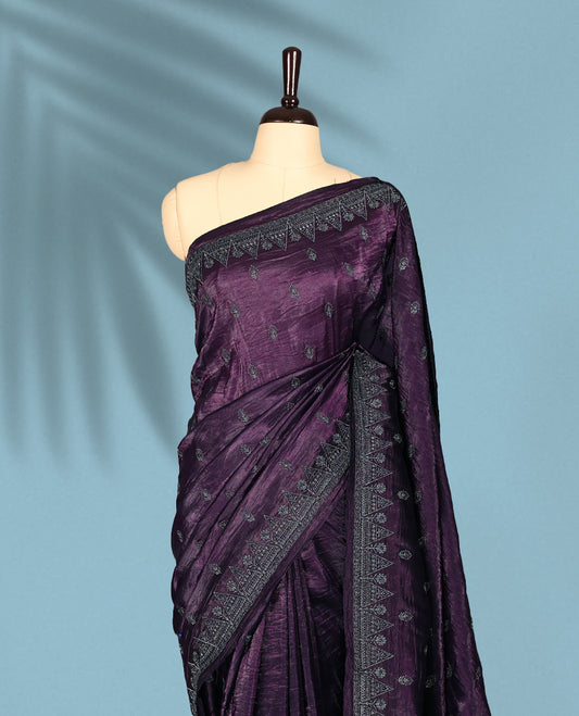 Deep Grape Colour crush soft silk saree, textured body with a natural crinkled finish, adorned with intricate Silver colored Flower like Motifs and complemented by a delicate Silver Zari embroidery border, paired with a matching blouse