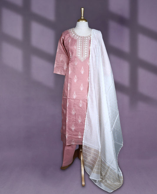 Dusty pink colour salwar set with ikat-inspired motifs and detailed mirror embroidery on the neckline, paired with plain bottom and an off white dupatta featuring golden striped detailing.