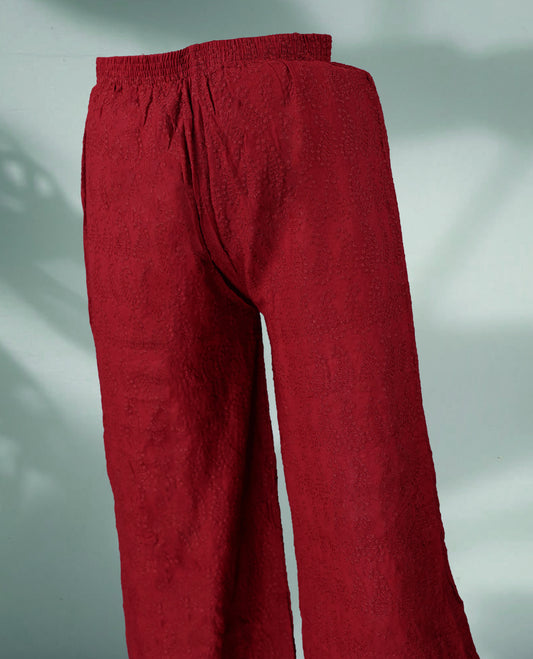 Maroon colour textured palazzo pants featuring an elasticated waistband and intricate woven patterns, offering comfort