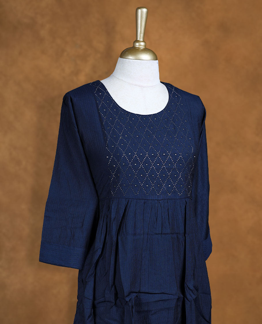 Navy blue colour kurti highlighted with a diamond-patterned cutwork yoke, styled with a scoop neckline, gathered waist and comfy 3/4th sleeves.