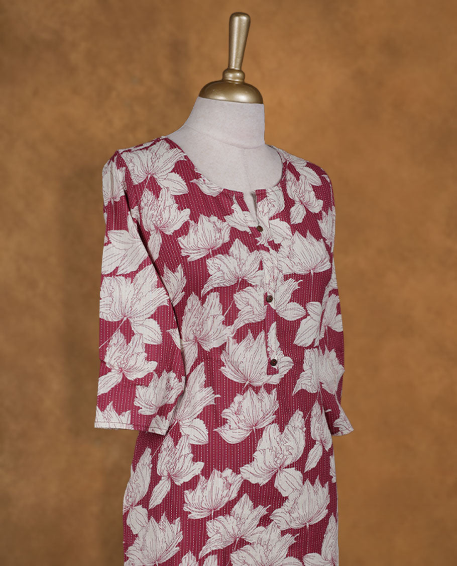 Light maroon colour kurti accentuated with cream floral motifs over subtle pinstripes, styled with a notched round neckline with button detailing and comfy 3/4th sleeves.