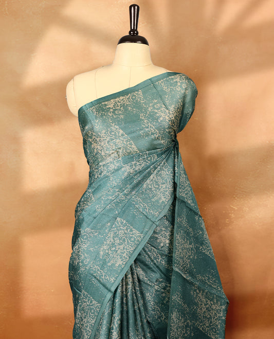 Pastel blue colour pure tussar silk light weight saree with full body abstract floral print, no defined border and pallu, paired with matching abstract printed blouse.