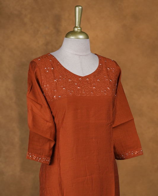Brick red colour kurti with, knee length design, styled with a Self colour thread pattern on round neckline and a sleeve .