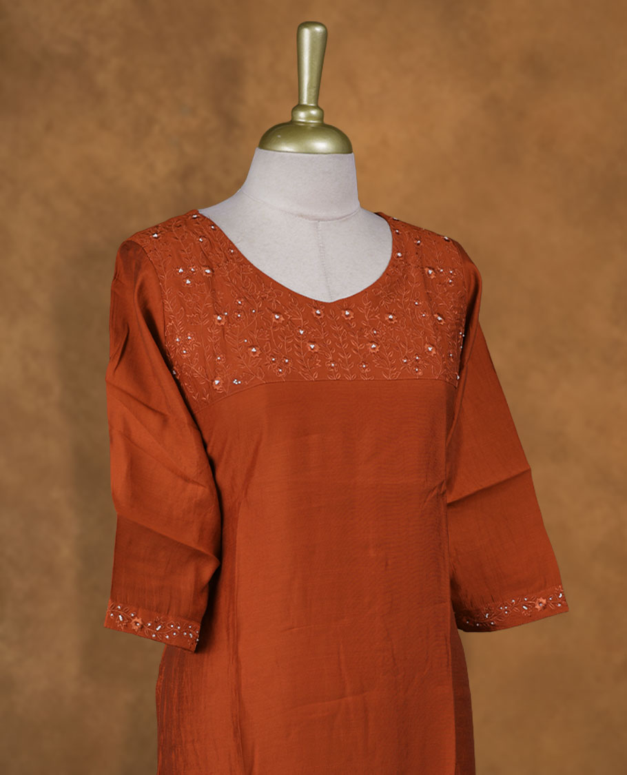 Brick red colour kurti with, knee length design, styled with a Self colour thread pattern on round neckline and a sleeve .