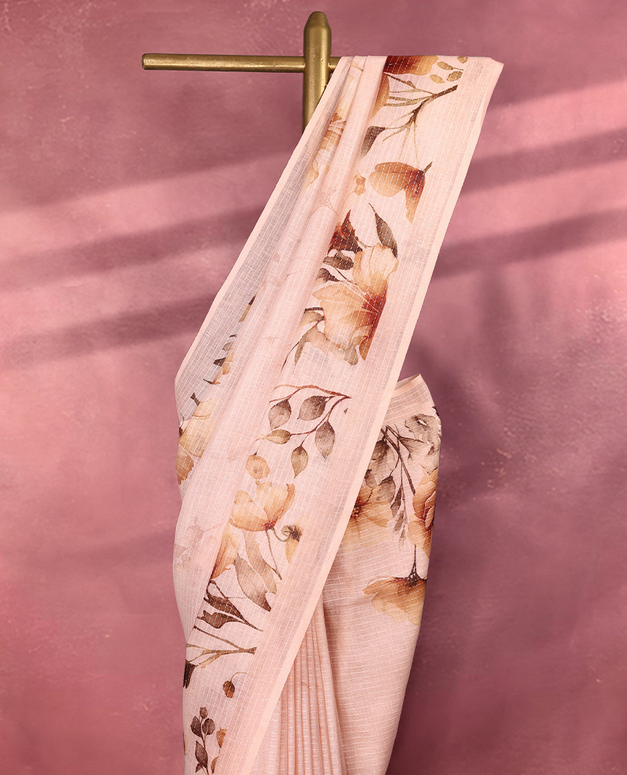 Light Pastel Peach colour pure linen saree featuring elegant floral prints in earthy tones all over the body, finished with a minimal border and comes with a matching blouse