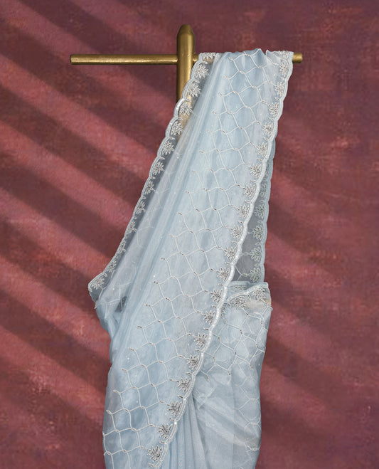 Light Pastel Blue colour pure organza saree featuring sequin work all over the body, adorned with a heavily embellished border with beads, stones, and sequins, complemented by a worked pallu and paired with a matching embellished blouse