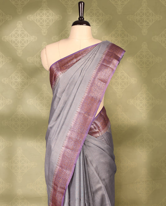 Grey colour pure Banaras tussar silk saree with light gold zari small checked body, contrast pastel purple border featuring copper and silver antique zari traditional work, antique zari brocade pallu, with matching blouse.