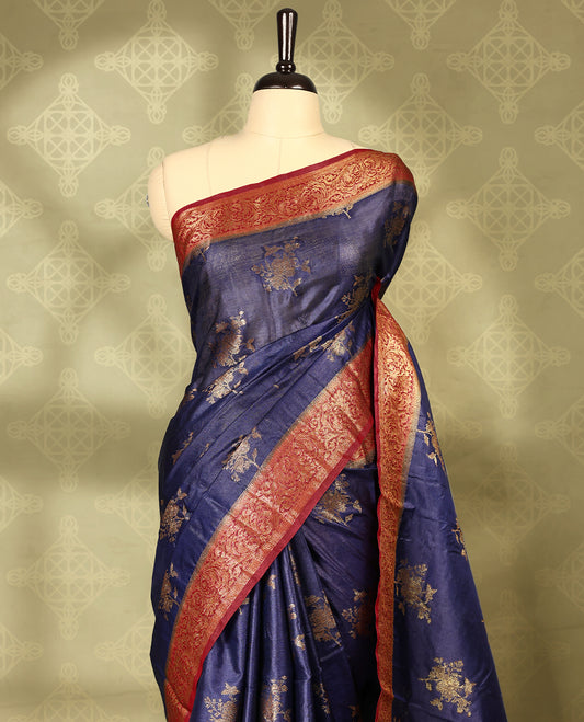 Deep Blue colour pure Banaras tussar silk saree with light gold zari traditional motifs on body, contrast deep red border featuring copper and silver antique zari traditional work, antique zari traditioal pallu, with matching blouse.