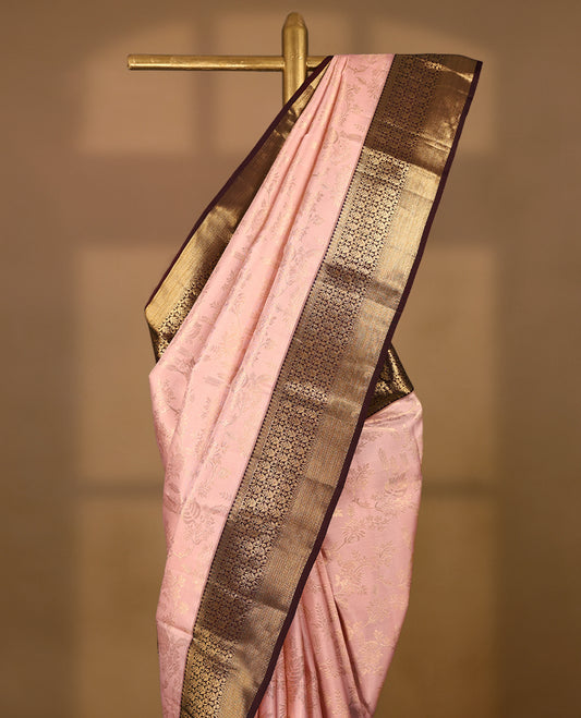 Soft blush Colour traditional Kancheepuram silk saree adorned with antique zari floral kodi motifs on the body, featuring a dark maroon border with rich, heavy golden zari floral Kodi patterns, and paired with a matching blouse.