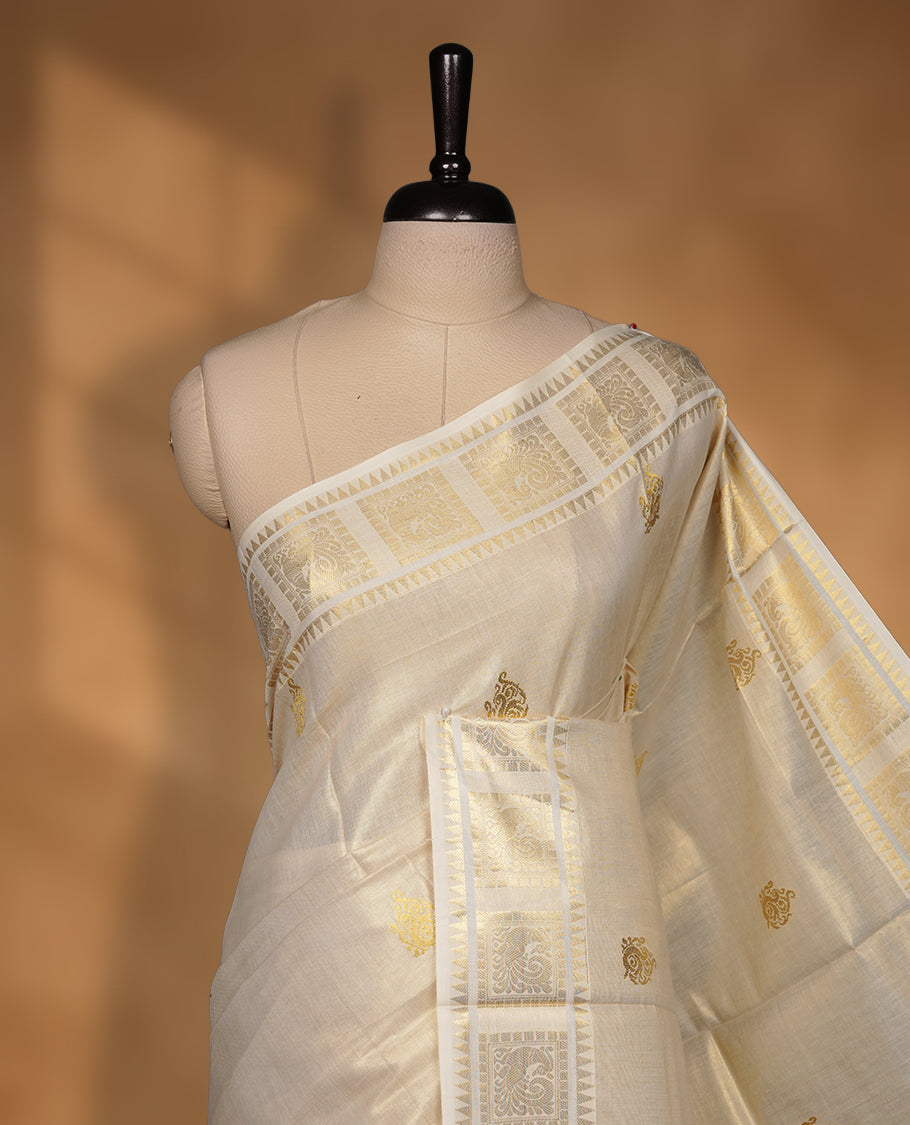 Elegant Light gold colour tissue Kerala saree with tree design gold zari buttas, broad kasavu border, and richly woven traditional pallu, paired with a matching blouse