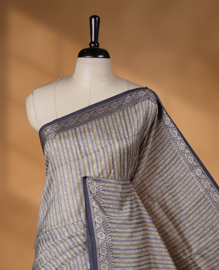Cream colour chanderi silk saree with ash & olive geometric stripped printed On body, compilmented by contrast Dark ash colour border with golden zari floral pattern and a matching blouse.
