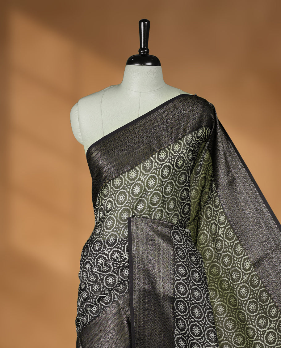 Olive colour chanderi silk saree with Floral block print On body, compilmented by  contrast dark green colour border with antique zari pattern and a matching blouse.