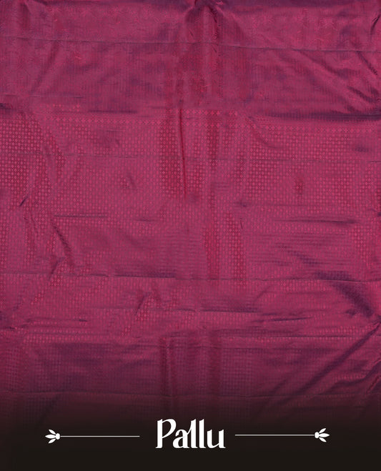 Wine colour semi soft silk saree featuring a self coloured textured patterned body, complemented by self coloured motifes on pallu & border and a matching blouse piece.