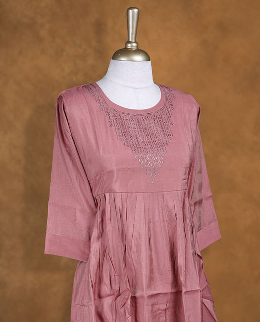 Coral pink colour kurti highlighted with delicate cutwork detailing along the scoop neckline, styled with gathered waist and comfy 3/4th sleeves.