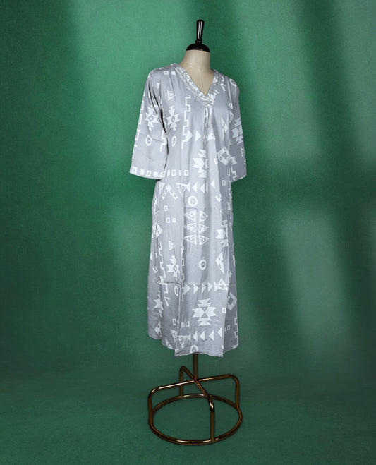 Light grey colour kurti featuring white tribalinspired geometric prints, styled with a V neckline adorned with subtle thread embroidery and 3/4th sleeves ideal for a contemporary ethnic look.