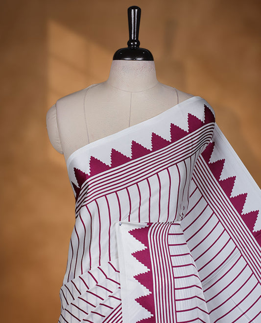 White colour semi modal saree featuring wine berry colour geometric borders and fine stripe detailing, finished with an oversized circular motif on the pallu, paired with a matching printed blouse.
