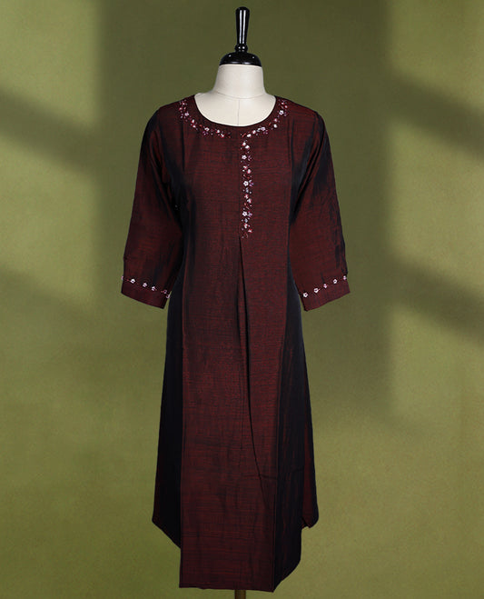 Maroon colour kurti featuring a round neck, three quarter sleeves, and delicate floral hand embroidery along the neckline and cuffs.