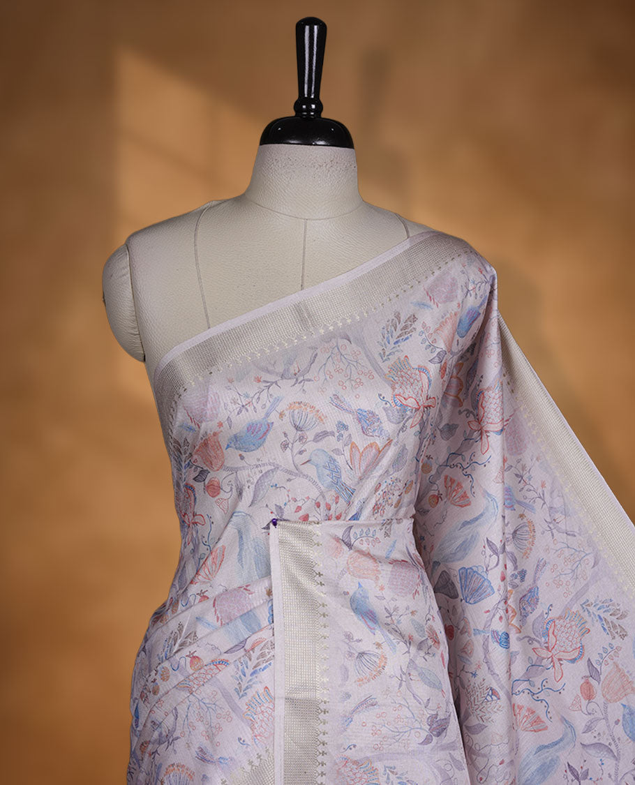 Light pink colour semi tussar silk saree featuring all over floral and leaf motifs on the body with a subtle self border and tasselled pallu, paired with a matching blouse.