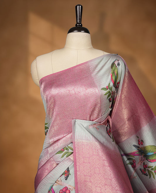 Dusty rose and silver colour semi tussar Banarasi saree featuring printed parrot and floral motifs, zari diamond buttas, a geometric gray-red zari border, and a matching blouse with woven accents.