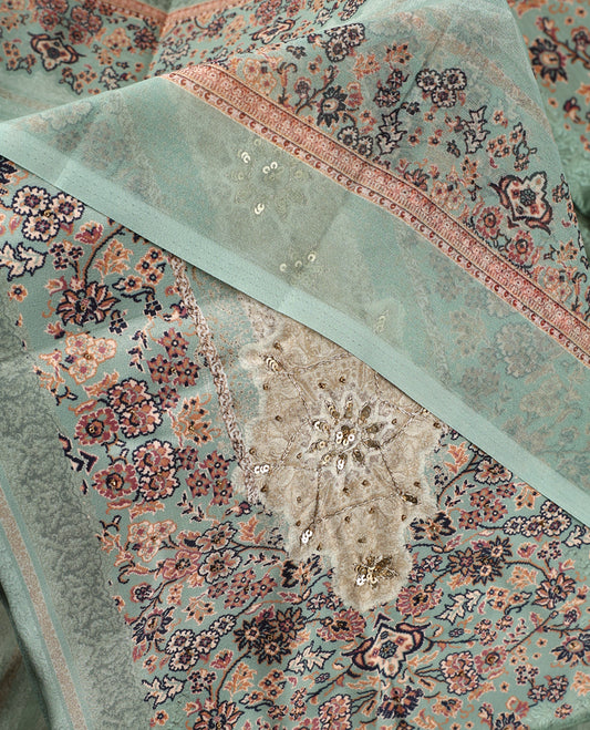 Pista green colour churidhar material with intricate floral prints, sequin embroidery on the top, plain matching bottom, and a coordinated dupatta.