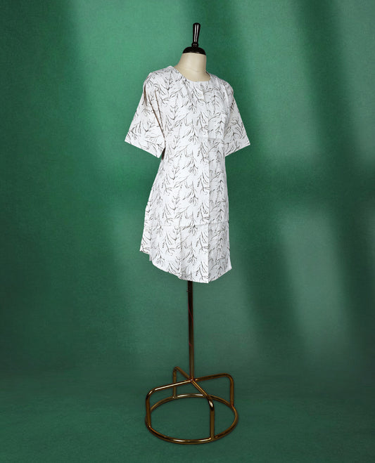White short kurti featuring a soft cotton base with elegant all over black leaf print, styled with a round neckline and elbow length sleeves for a casual and breezy everyday look