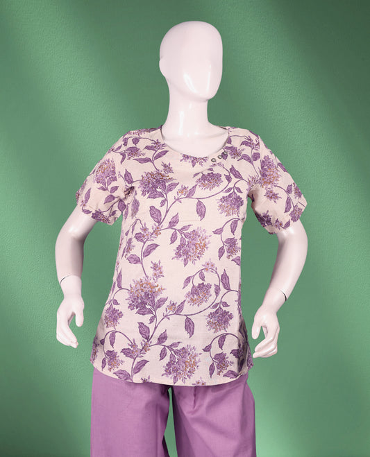 Pastel Purple colour women's nightwear set featuring a round-neck floral-printed top with short short sleeves, paired with solid straight-fit pants for a stylish and cozy appeal.