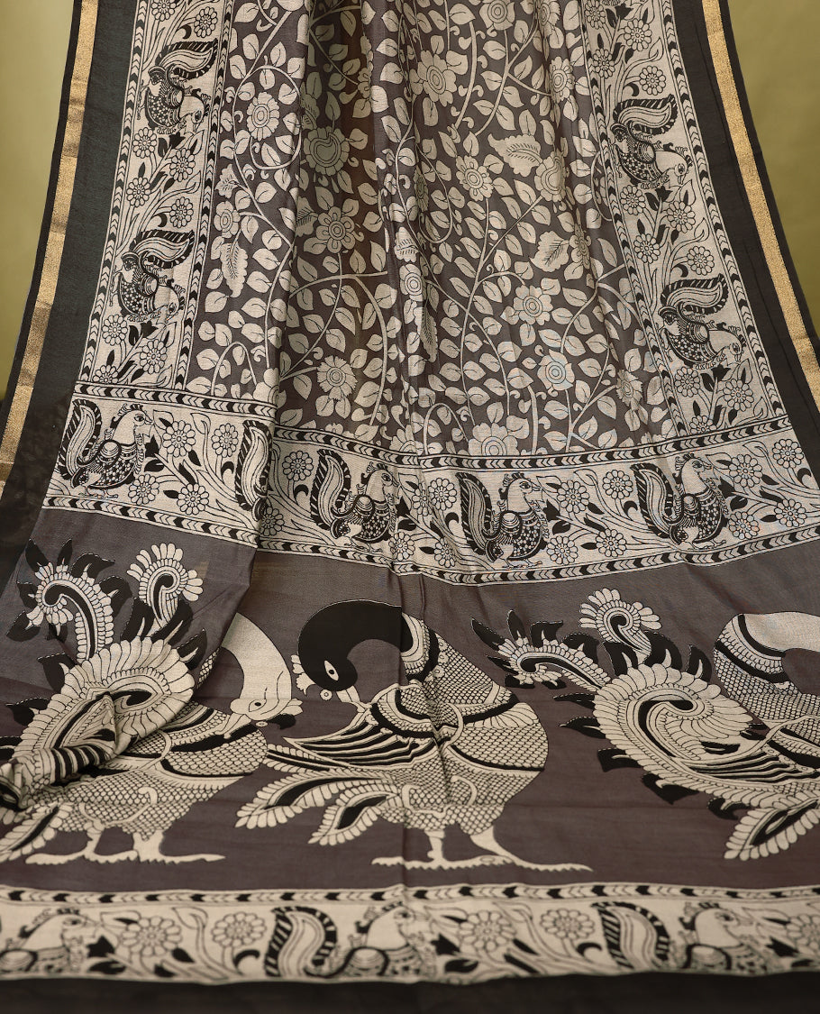 Deep Grey colour chanderi cotton saree with white floral Kodi printed body, Black border with peacock and floral motifs, grand pallu featuring large peacock designs, with matching blouse