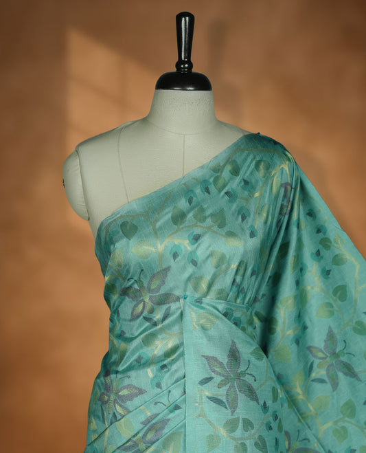 Mint colour semi tussar saree featuring woven Floral kodi & butterfly motifs on the body, complemented by a self colour without border pallu, paired with a matching blouse.
