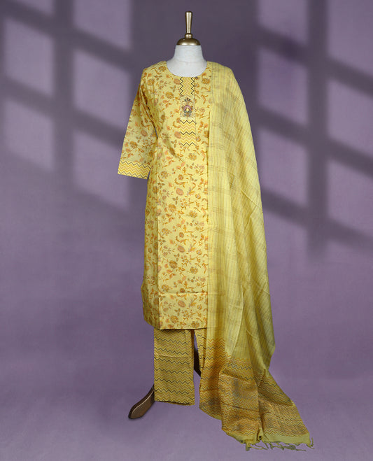 Sunshine yellow colour kurti set featuring a round neckline, three-quarter sleeves, floral and chevron block prints, paired with matching printed pants and a striped dupatta with chevron border accents.