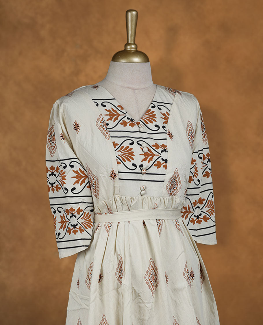 Ivory printed knee-length A-line dress with V-neckline, earthy geometric and floral motifs, three-quarter sleeves, and a detachable waist belt for a flattering fit.