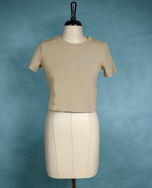 Beige colour fitted T shirt with short sleeves and subtle stud detailing on the shoulders, offering a clean and minimalistic look.