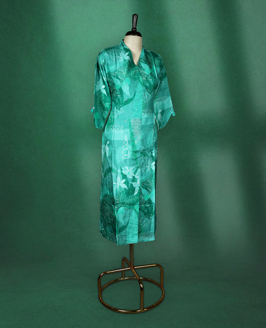 Teal green straight cut kurti with tonal abstract prints and delicate stone work on the body, featuring a V neck with notched collar and elbow length sleeves with button tabs.