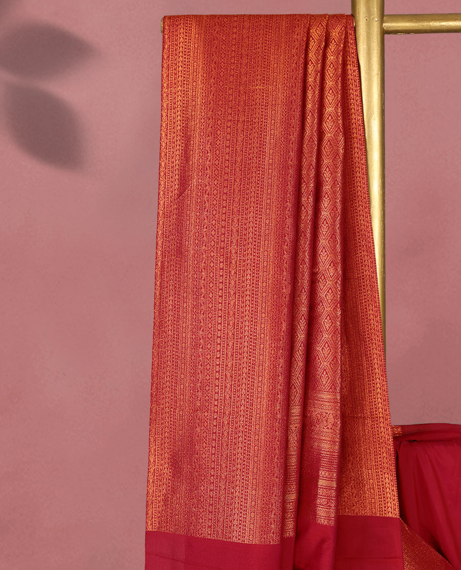 Dark Red colour Kancheepuram saree featuring an antique zari brocade body, complemented by a traditional border and a matching blouse.
