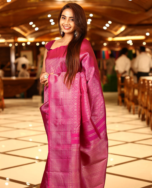 Deep magenta colour pure Kancheepuram brocade silk saree featuring a brocade body, antique brocade border with nellikamalam and mayilkannu motifs, diamond and kodivishari woven pallu, paired with a diamond-patterned brocade blouse.