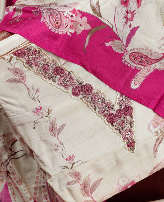 Cream colour churidhar material with pink floral and paisley prints, enhanced by a magenta border and delicate embroidery & Comes with matching plain bottom and dupatta.