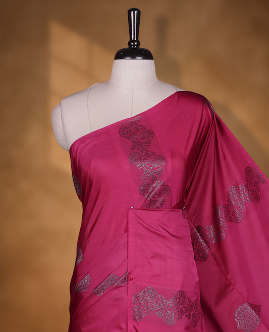 Magneta colour semi soft silk saree adorned with delicate woven floral motifs on the body, complemented by a contrast blue colour woven pallu with intricate detailing and tassel accents without border & Comes with a matching blouse piece.