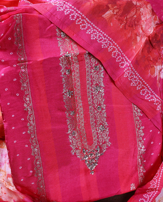 Vibrant pink colour churidhar material with intricate embroidery on the neckline and delicate floral prints, paired with a matching printed dupatta and a plain bottom.