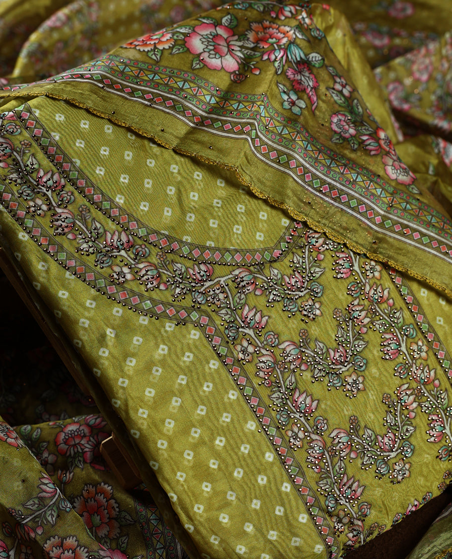 Mustard yellow churidhar material beautifully designed with intricate floral, stone and vine prints, paired with a matching plain bottom and elegant printed dupatta, perfect for festive and traditional wear.