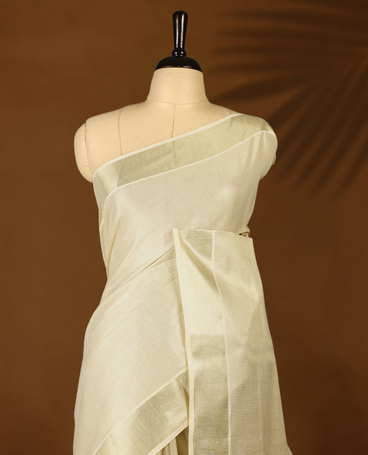 Light Gold colour Tissue Kerala saree featuring Plain body and a beautifully woven light Gold Kasavu border, paired with a matching blouse perfect for festive occasions.