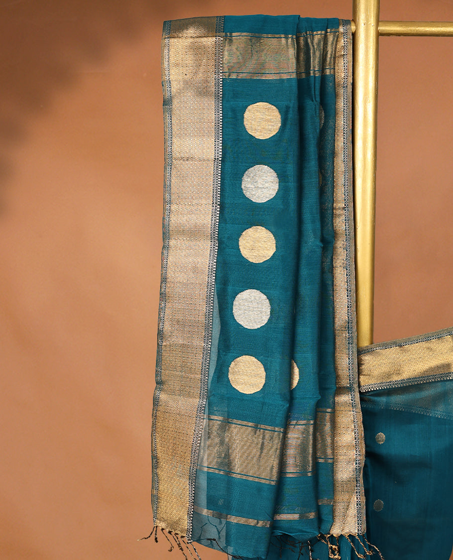 Peacock Blue colour Maheshwari Cotton saree featuring Antique Zari bindi Patterns across the entire body, complemented by a traditional Gold Zari border & Pallu, with a matching blouse.