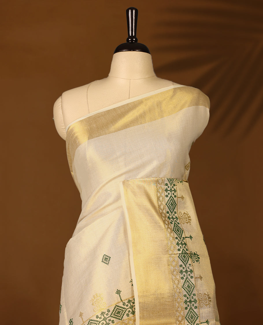 Elegant Light Gold colour Tissue Kerala saree featuring Green & gold geometric pattern embroidery worked body and traditional golden zari kasavu border offering a classic and graceful look, paired with a matching blouse.