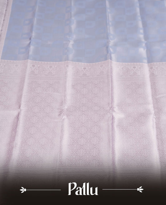 Light lavender colour semi silk saree adorned with subtle silver zari motifs on the body, complemented by a pastel light blue pallu intricately woven with rich floral patterns border and pallu, and paired with a matching blouse