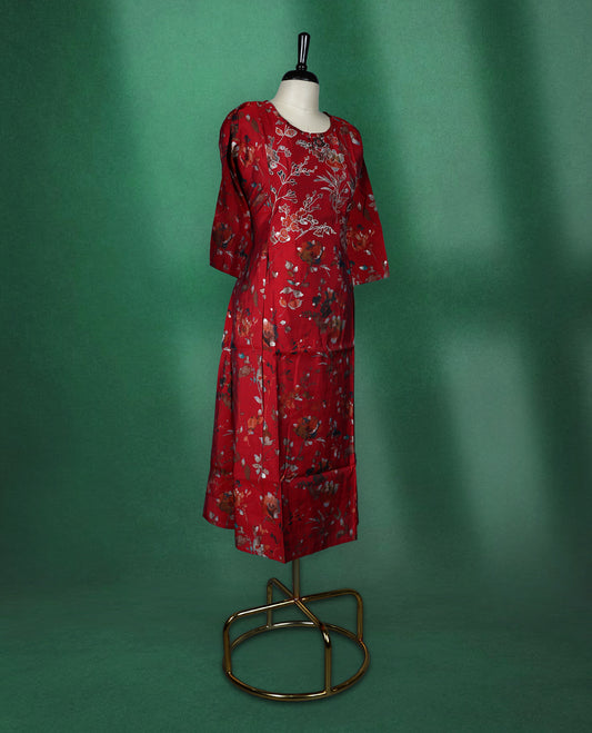 Elegant red kurti with all over floral print, styled with a round neckline, elbow length sleeves, and a straight cut silhouette perfect for casual or semi formal wear.