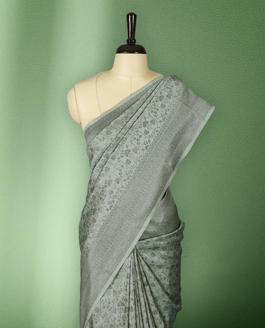 Light Pastel Green colour semi silk saree featuring neem zari floral kodi motifs all over the body, complemented by a rich self colour woven border, with matching blouse.